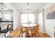 Cozy dining area with natural light, hardwood floors, stylish seating, and a view of the kitchen at 6045 Crittenden Ave, Indianapolis, IN 46220