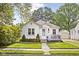 Charming home featuring a well-kept lawn, inviting front porch, and beautiful, traditional architectural details at 6045 Crittenden Ave, Indianapolis, IN 46220