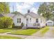 Lovely exterior showcases a manicured lawn, a quaint front porch, and timeless architectural elements at 6045 Crittenden Ave, Indianapolis, IN 46220