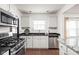 Modern kitchen with stainless steel appliances, sleek countertops, and ample cabinet space at 6045 Crittenden Ave, Indianapolis, IN 46220
