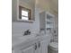 Updated bathroom with white vanity and storage shelving at 617 Echo Bend Blvd, Greenwood, IN 46142