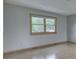 Bright room with laminate floors and a large window providing natural light and outdoor views at 617 Echo Bend Blvd, Greenwood, IN 46142