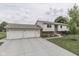 Home with a two-car garage, wide driveway, and well-maintained landscaping surrounding the property at 617 Echo Bend Blvd, Greenwood, IN 46142