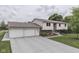 Spacious home with a two-car garage and expansive driveway, set against a lush, green landscape at 617 Echo Bend Blvd, Greenwood, IN 46142