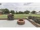 Inviting backyard features a fire pit and wood storage, creating a cozy outdoor space at 617 Echo Bend Blvd, Greenwood, IN 46142