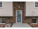 Home's brick entryway and front door, with greenery and details that give a warm welcome at 617 Echo Bend Blvd, Greenwood, IN 46142