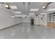 Spacious garage with epoxy flooring, fluorescent lighting, and plenty of storage space at 617 Echo Bend Blvd, Greenwood, IN 46142