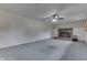 Expansive living room features a rustic brick fireplace, ceiling fan, and plush carpeting at 617 Echo Bend Blvd, Greenwood, IN 46142