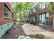 Serene courtyard with lush greenery, seating areas, and charming brick walkways at 624 E Walnut St # 48, Indianapolis, IN 46204