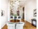 Dining area with a round table and elegant chandelier, open to kitchen at 624 E Walnut St # 48, Indianapolis, IN 46204