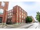 Brick apartment building with large windows offering abundant natural light and street view at 624 E Walnut St # 48, Indianapolis, IN 46204