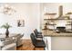 Modern kitchen featuring granite countertops, stainless steel appliances, and floating wood shelves at 624 E Walnut St # 48, Indianapolis, IN 46204