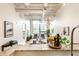 Open concept living room with kitchen view, featuring industrial ceilings and expansive windows at 624 E Walnut St # 48, Indianapolis, IN 46204