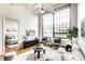Airy living room with hardwood floors, a ceiling fan, and a view into the open bedroom at 624 E Walnut St # 48, Indianapolis, IN 46204