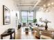 Open concept living and dining area with hardwood floors and large windows providing natural light at 624 E Walnut St # 48, Indianapolis, IN 46204