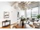 Spacious open-concept living and dining area with hardwood floors, stylish furnishings and natural light at 624 E Walnut St # 48, Indianapolis, IN 46204