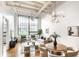 Bright living room with high ceilings, exposed ductwork, large window, and modern furnishings at 624 E Walnut St # 48, Indianapolis, IN 46204