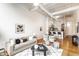 Bright open-concept living and dining area with hardwood floors and modern furnishings at 624 E Walnut St # 48, Indianapolis, IN 46204
