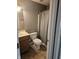 Clean bathroom with a vanity, toilet, shower and tub combo with a shower curtain, and neutral tones at 7307 Barnwell Pl, Indianapolis, IN 46217
