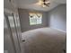Bright bedroom with a ceiling fan and natural light pouring through the window at 7307 Barnwell Pl, Indianapolis, IN 46217