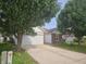 Charming exterior view of a home with a two-car garage and a long driveway at 7307 Barnwell Pl, Indianapolis, IN 46217