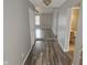 Inviting hallway features wood-look flooring and access to the living area and a bathroom at 7307 Barnwell Pl, Indianapolis, IN 46217