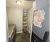 Functional laundry room with washer, dryer, shelving, and storage space for household needs at 7307 Barnwell Pl, Indianapolis, IN 46217