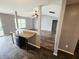 Open-concept living area with a kitchen island and a view into the spacious, naturally lit living room at 7307 Barnwell Pl, Indianapolis, IN 46217