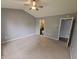 Spacious bedroom features a ceiling fan and convenient access to an attached bathroom at 7307 Barnwell Pl, Indianapolis, IN 46217