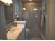 Well lit bathroom featuring a glass shower door and updated vanity at 7357 Lake Lakota Dr, Indianapolis, IN 46217