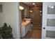 Bathroom with a glass-enclosed shower, white vanity and door entrance at 7357 Lake Lakota Dr, Indianapolis, IN 46217