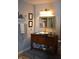 Bathroom with stylish vanity with elegant lighting and a decorative mirror at 7357 Lake Lakota Dr, Indianapolis, IN 46217