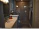 Modern bathroom featuring a walk-in shower, neutral tile, and plenty of vanity storage at 7357 Lake Lakota Dr, Indianapolis, IN 46217