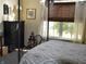 Cozy bedroom with a comfortable bed, dark wood furniture, and bright natural light at 7357 Lake Lakota Dr, Indianapolis, IN 46217