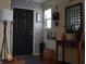 Inviting entryway featuring a dark door and stylish decorations on a console table at 7357 Lake Lakota Dr, Indianapolis, IN 46217
