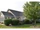 Charming brick home with well-maintained landscaping, mature tree, and inviting curb appeal at 7357 Lake Lakota Dr, Indianapolis, IN 46217