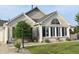 Charming brick home featuring a well-manicured lawn, trimmed shrubs, and a cozy front porch at 7357 Lake Lakota Dr, Indianapolis, IN 46217