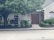Inviting brick home with a beautiful front entrance, manicured landscaping, and an ADT security system at 7357 Lake Lakota Dr, Indianapolis, IN 46217