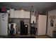 Well-organized garage features white cabinets, utility sink, and updated water heater system for convenience at 7357 Lake Lakota Dr, Indianapolis, IN 46217