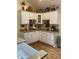 Charming kitchen featuring white cabinets with stylish decor on top and hardwood floors at 7357 Lake Lakota Dr, Indianapolis, IN 46217