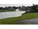 Scenic view of the tranquil lake, showcasing lush green lawns and a serene fountain at 7357 Lake Lakota Dr, Indianapolis, IN 46217