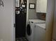 Convenient laundry room with modern white washer and dryer, plus extra cabinet storage at 7357 Lake Lakota Dr, Indianapolis, IN 46217