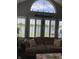 Relaxing living room showcases a comfortable sofa and a stunning lake view through shuttered windows at 7357 Lake Lakota Dr, Indianapolis, IN 46217