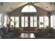 Bright living room features a vaulted ceiling, large windows with shutters and comfortable seating at 7357 Lake Lakota Dr, Indianapolis, IN 46217