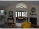 Inviting living room with vaulted ceiling, fireplace, and an open layout into another seating area at 7357 Lake Lakota Dr, Indianapolis, IN 46217