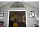 Inviting living room showcasing an open doorway and decorative arched window accent at 7357 Lake Lakota Dr, Indianapolis, IN 46217