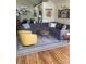 Cozy living room with hardwood floors, a large gray sofa, and a bright yellow accent chair at 7357 Lake Lakota Dr, Indianapolis, IN 46217