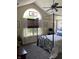 Serene bedroom features a four-poster bed, ceiling fan, and arched window with decorative touches at 7357 Lake Lakota Dr, Indianapolis, IN 46217