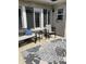 A cozy outdoor patio with comfortable seating, an area rug, and a brick exterior at 7357 Lake Lakota Dr, Indianapolis, IN 46217