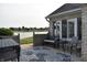 Charming patio with an outdoor seating area, complemented by a leaf patterned rug and scenic lake views at 7357 Lake Lakota Dr, Indianapolis, IN 46217